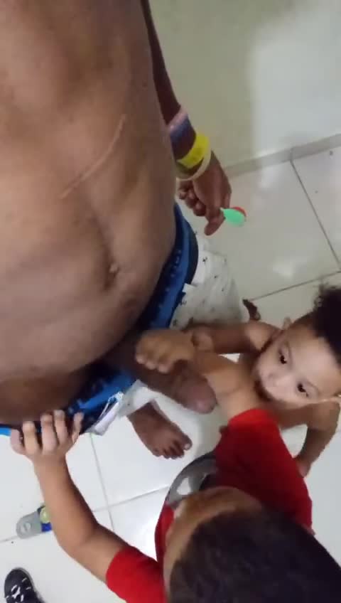 Two toddler kids playing with dady